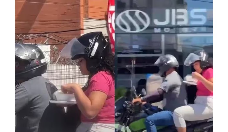 Mulher é flagrada no trânsito comendo marmita em garupa de moto e vídeo viraliza